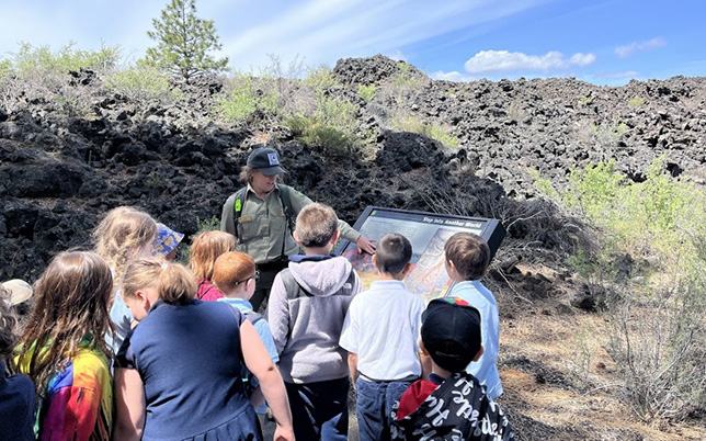Groups of kids with a ranger in a lava field
